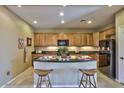 Charming kitchen featuring a breakfast bar and stainless steel appliances at 23317 N Arrellaga Dr, Sun City West, AZ 85375