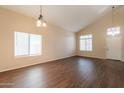 Bright living room featuring hardwood floors, vaulted ceilings, and lots of natural light at 33055 N Madison Way Dr, San Tan Valley, AZ 85144