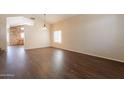 Bright living room featuring hardwood floors, vaulted ceilings, and a large window at 33055 N Madison Way Dr, San Tan Valley, AZ 85144