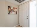 Clean hallway with a door and painting adding a touch of elegance to the space at 3600 N 5Th Ave # 302, Phoenix, AZ 85013