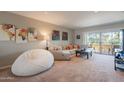 Comfortable living room featuring a soft sofa and beanbag, with balcony access at 3600 N 5Th Ave # 302, Phoenix, AZ 85013