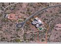 An aerial view showing the property's location, surrounded by lush desert landscaping with a pool and ample privacy at 36389 N 105Th Pl, Scottsdale, AZ 85262