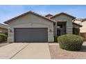 Charming home featuring a gray garage door, neutral exterior, and desert landscaping at 4314 E Anderson Dr, Phoenix, AZ 85032