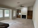 Bright living room with a fireplace, wet bar, built-in shelving and large windows at 4801 E Sheena Dr, Scottsdale, AZ 85254