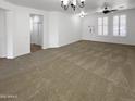 Spacious carpeted living room with white walls and ample natural light showcases a welcoming atmosphere at 5140 W Bent Tree Dr, Phoenix, AZ 85083