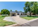 Charming single-story home features an attached carport and well-maintained front yard at 6302 N 13Th Pl, Phoenix, AZ 85014