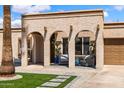 Inviting single-story home showcases a stucco facade, arched entryway, and well-manicured landscaping at 858 W Knowles Cir, Mesa, AZ 85210