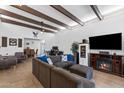 Spacious living room with wood-beamed ceilings, tile flooring, and comfortable seating area at 858 W Knowles Cir, Mesa, AZ 85210