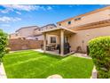 Enjoy the outdoors with a covered patio and artificial turf, perfect for entertaining at 8788 W Wood Dr, Peoria, AZ 85381