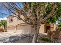 Charming home featuring a spacious two-car garage and mature desert landscaping at 8788 W Wood Dr, Peoria, AZ 85381
