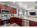 Updated kitchen boasts stainless steel appliances, granite countertops, and ample cabinet space at 8788 W Wood Dr, Peoria, AZ 85381