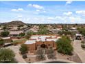 Aerial view of charming home with desert landscaping and mountain views at 9435 E Hobart Cir, Mesa, AZ 85207