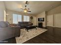 Spacious living room with a ceiling fan, wood floors, and comfortable furnishings at 9983 W Monterosa Ave, Phoenix, AZ 85037