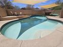 Inviting pool features tiled steps and is surrounded by a concrete patio and artificial turf at 9983 W Monterosa Ave, Phoenix, AZ 85037
