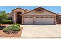 Charming single-story home featuring a spacious driveway, desert landscaping, and a two-car garage at 11023 W Chino Dr, Peoria, AZ 85373