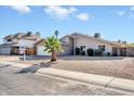 Charming single-story home featuring a two-car garage and a well-maintained, low-maintenance yard with a young palm tree at 11044 N 75Th Dr, Peoria, AZ 85345