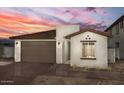 Stylish single-story home featuring brick accents, a cozy front yard, and a two-car garage at 18180 W Larkspur Dr, Goodyear, AZ 85338