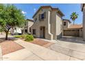 Two-story home with neutral stucco, an attached two-car garage and low maintenance landscaping at 18877 E Pelican Dr, Queen Creek, AZ 85142