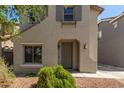 Two-story home showcasing a well-manicured front yard with decorative rock and shrubbery at 18877 E Pelican Dr, Queen Creek, AZ 85142