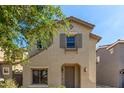 Charming two-story home with neutral stucco, gray shutters, and a well-maintained front yard at 18877 E Pelican Dr, Queen Creek, AZ 85142