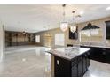 Open floor plan showcasing the kitchen with island and living area with custom built-ins at 2194 N Magdelena Pl, Casa Grande, AZ 85122