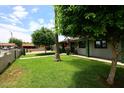 Charming single-story home with a well-manicured lawn and a quaint, inviting front porch at 2916 N 48Th Ave, Phoenix, AZ 85031