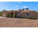 Single-story home with desert landscaping, covered entryway, and attached garage, blending charm and practicality at 3034 E Turney Ave, Phoenix, AZ 85016