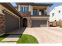 Home featuring a two-car garage and well designed brick and facade at 3408 E Daley Ln, Phoenix, AZ 85050