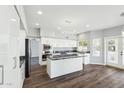 Modern kitchen with white cabinets, granite countertops, stainless steel appliances, and sleek lighting at 3641 E Park Ave, Phoenix, AZ 85044
