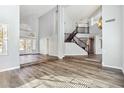 Bright living room with hardwood floors, high ceilings, large windows, and an open staircase at 3641 E Park Ave, Phoenix, AZ 85044