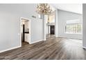 Living room featuring soaring ceilings, wood floors, and a view into the kitchen at 3641 E Park Ave, Phoenix, AZ 85044
