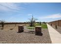 A picturesque community park featuring a white fence, walking paths, and ample green space at 38469 N Pheasant St, San Tan Valley, AZ 85140