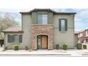 This lovely home boasts a stone-accented entry, neutral tones, and neat landscaping for a welcoming facade at 3983 E Melinda Dr, Phoenix, AZ 85050