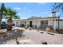 Charming single-story home featuring desert landscaping, mature trees, and a welcoming front porch at 405 W Monte Way, Phoenix, AZ 85041