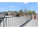 View of the home from behind the gated entrance with desert landscaping and long drive at 405 W Monte Way, Phoenix, AZ 85041