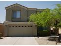 Two-story home featuring an attached two-car garage and easy-care desert landscaping for water conservation at 43241 W Kristal Ln, Maricopa, AZ 85138