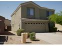 Two-story home featuring an attached two-car garage and easy-care desert landscaping in a suburban setting at 43241 W Kristal Ln, Maricopa, AZ 85138