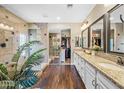 Spacious bathroom featuring a walk-in shower, dual sinks with granite countertops, and a closet at 683 W Honey Locust Ave, Queen Creek, AZ 85140
