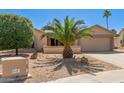 Charming single-story home featuring desert landscaping and an attached two-car garage at 9857 W Tonto Ln, Peoria, AZ 85382
