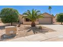 Charming single-story home featuring desert landscaping and an attached two-car garage at 9857 W Tonto Ln, Peoria, AZ 85382
