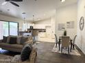 Open-concept floorplan with cozy living room with kitchen island at 10341 E Dragoon Ave, Mesa, AZ 85208