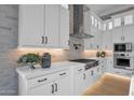 Modern kitchen with white cabinets, stainless steel appliances, and a stylish brick backsplash at 1111 E Peach Tree Dr, Chandler, AZ 85249