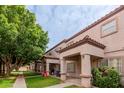 Charming townhome exterior with well-manicured lawn and mature trees at 125 S 56Th St # 124, Mesa, AZ 85206