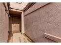 Close-up of covered walkway to front door with beige textured walls at 125 S 56Th St # 124, Mesa, AZ 85206
