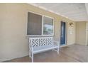 Inviting front porch featuring a stylish bench and view of the home's entrance and covered porch area at 1719 E Dana Ave, Mesa, AZ 85204