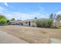 Charming single-story home with a covered front porch and a well-maintained yard in a quiet neighborhood at 1719 E Dana Ave, Mesa, AZ 85204