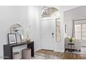Inviting entryway with a high ceiling, decorative mirror, and a view into the living area at 17827 N 51St Way, Scottsdale, AZ 85254