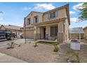 Charming two-story home featuring a well-manicured front yard and inviting covered porch at 17935 W Louise Dr, Surprise, AZ 85387