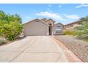 Well-maintained single-story home featuring a two-car garage, desert landscaping, and a paved driveway at 18644 N 21St St, Phoenix, AZ 85024