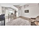 Bright living space with wood-look flooring, a neutral rug, and a seating arrangement, creating a cozy atmosphere at 18644 N 21St St, Phoenix, AZ 85024